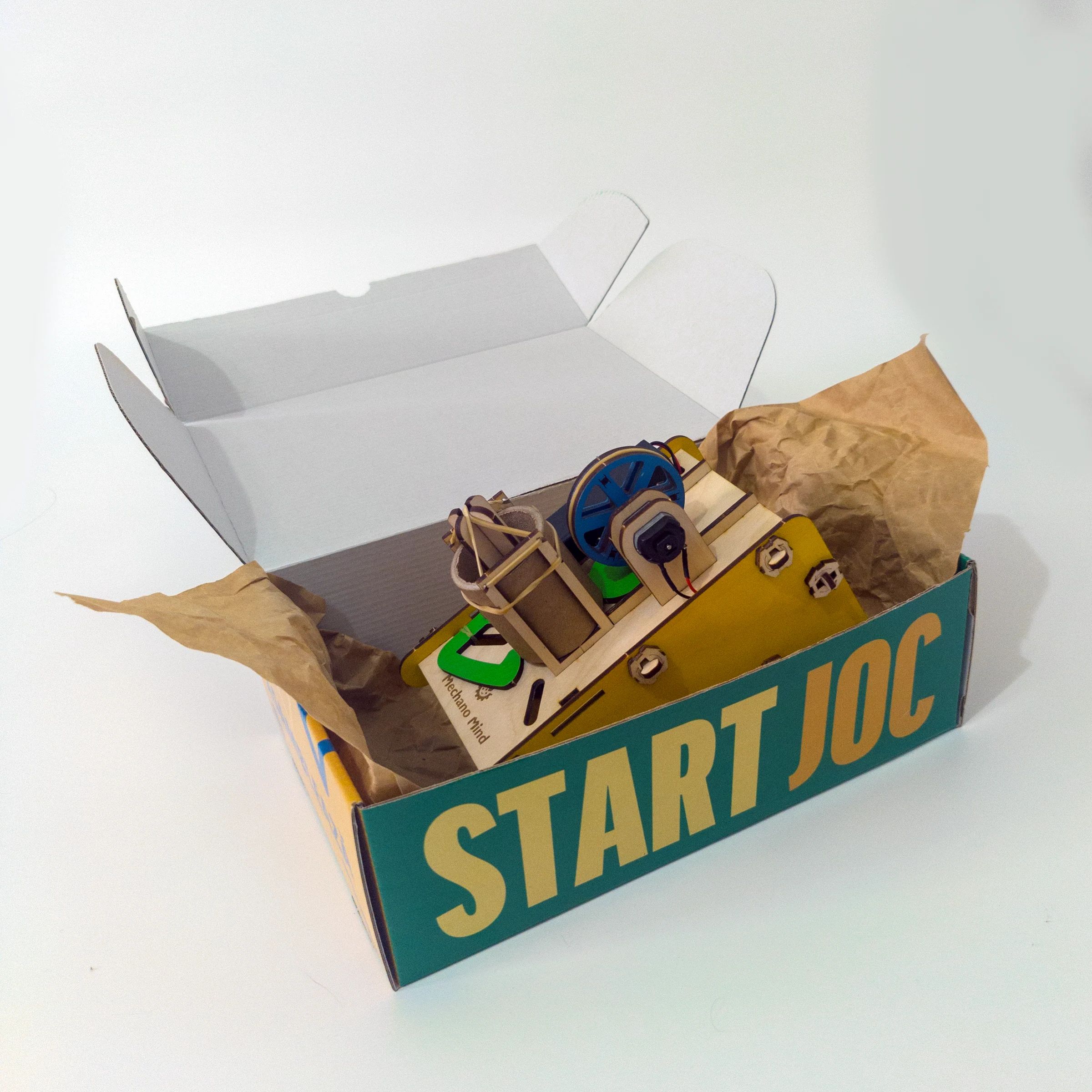 Disk launcher emerging from its illustrated cardboard packaging
