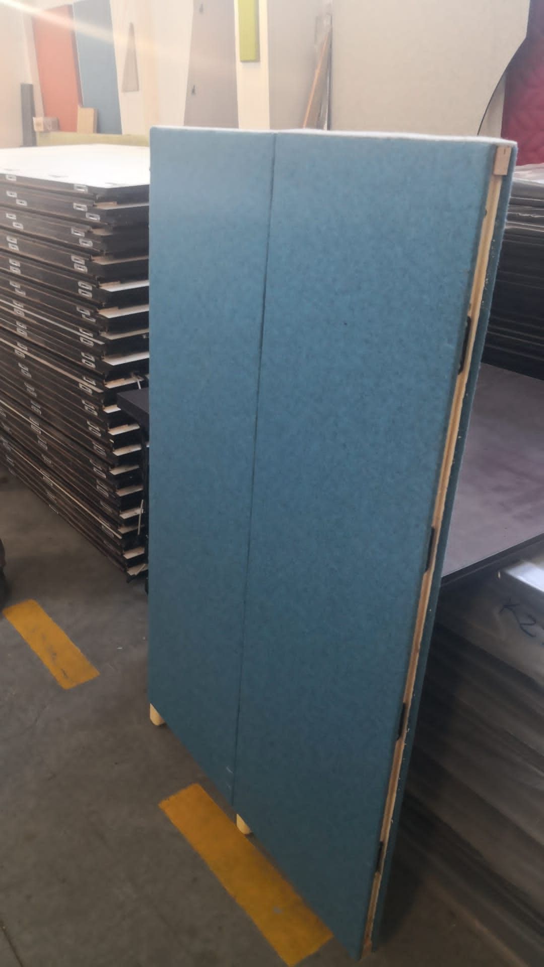Workshop prototype showing two upholstered acoustic panels joined at a corner