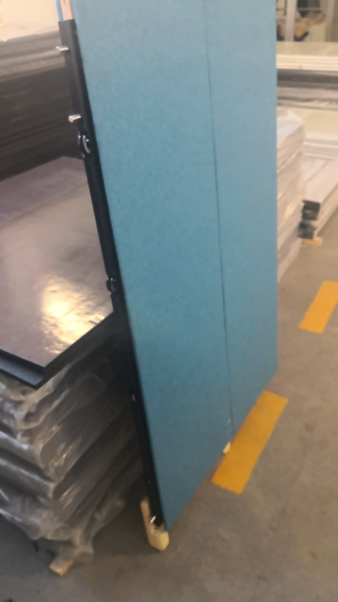 Full-height upholstered panel prototype photographed in the workshop