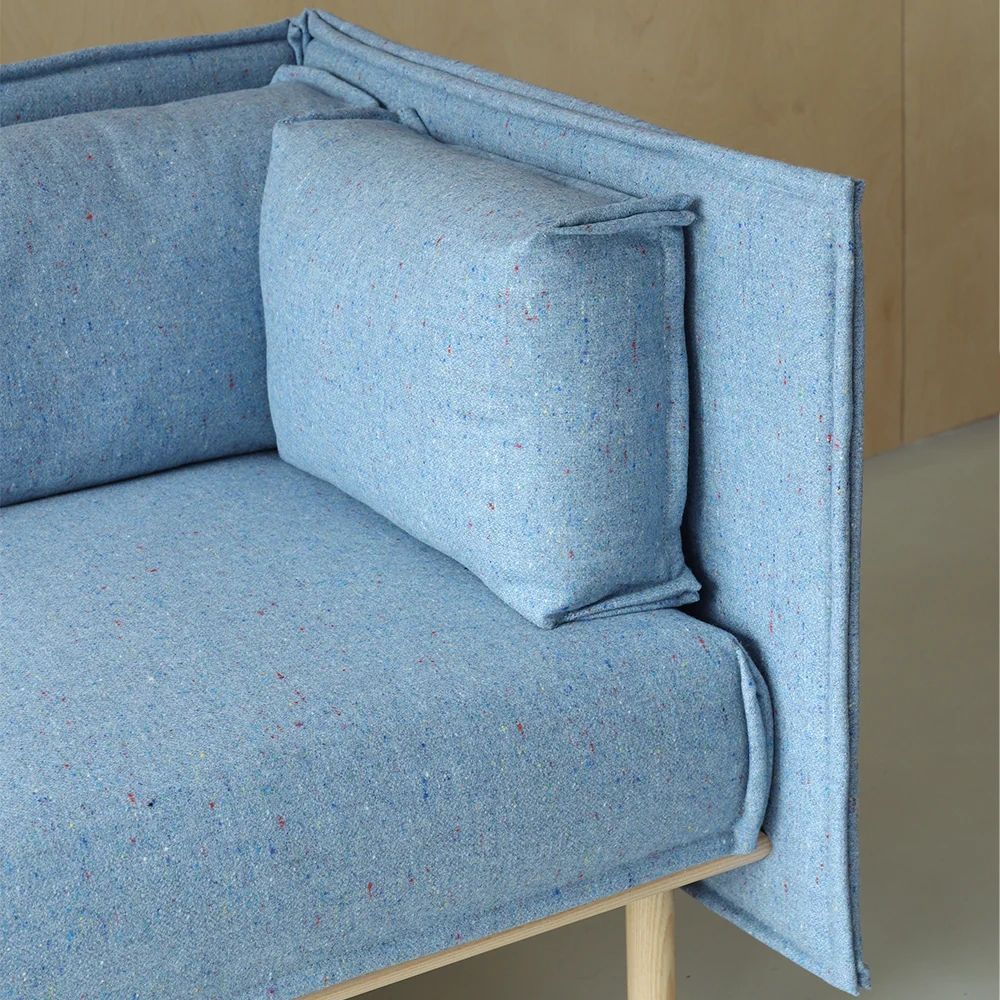 Close-up of the blue upholstered modular seating and its side panel