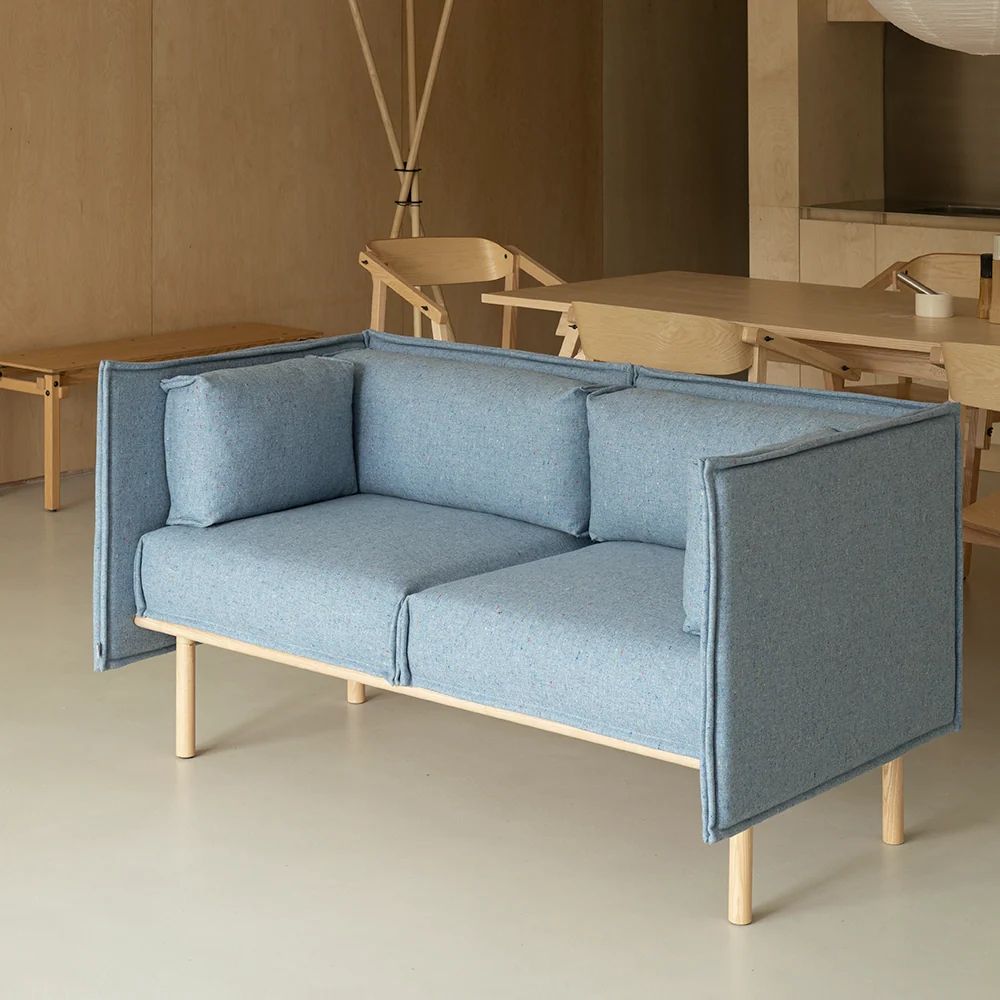 Blue two-seat modular sofa with high upholstered side panels