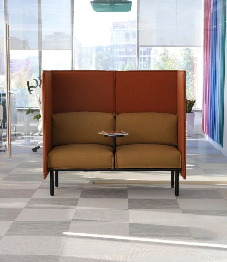 High-back modular sofa in a bright office interior