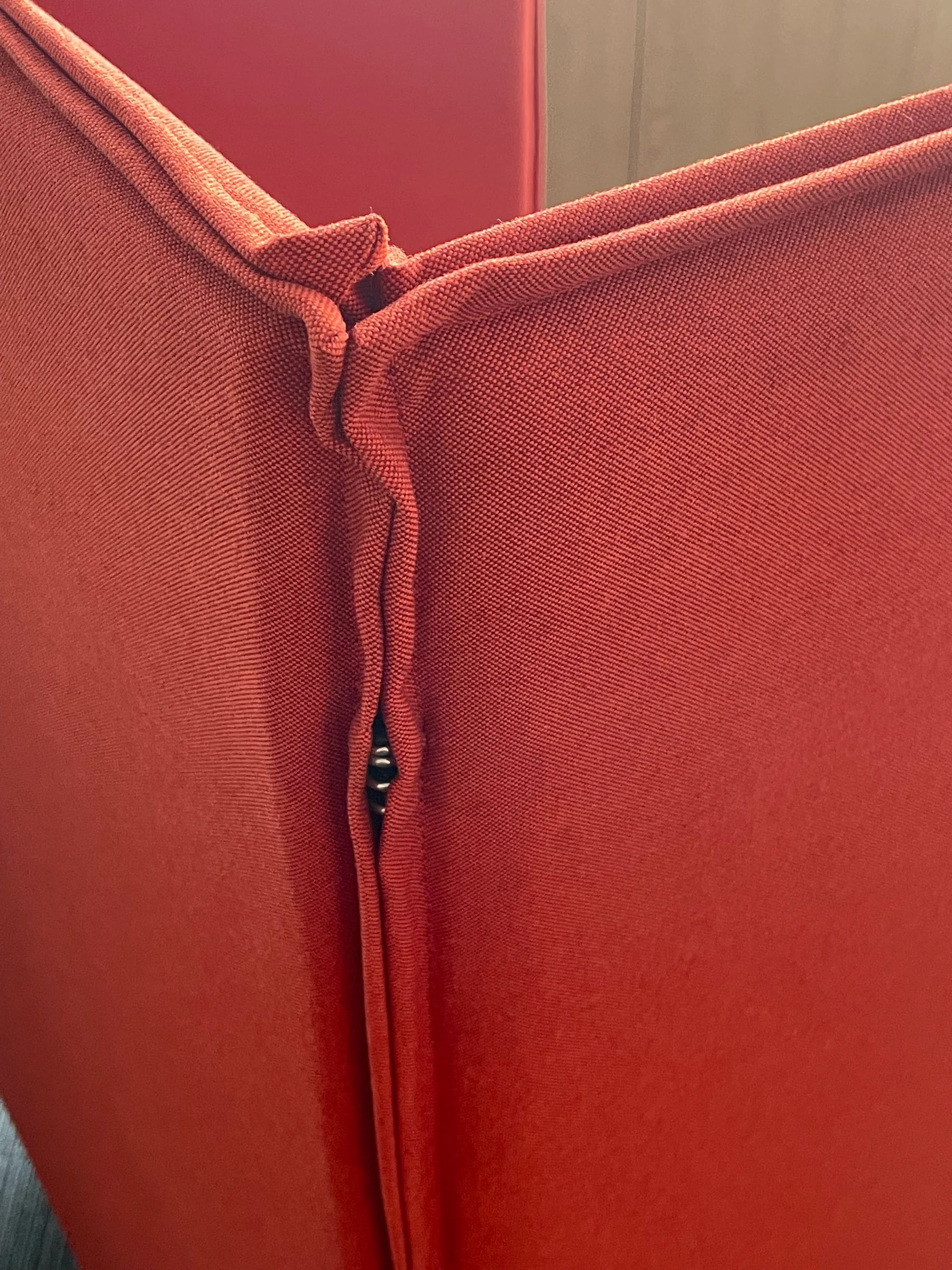 Detail of a red upholstered high-back seating panel
