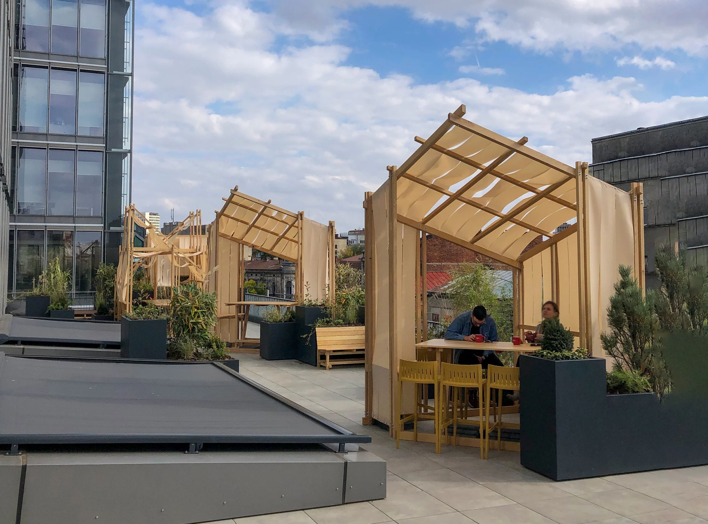 Solid white ash pavilions on an office building terrace