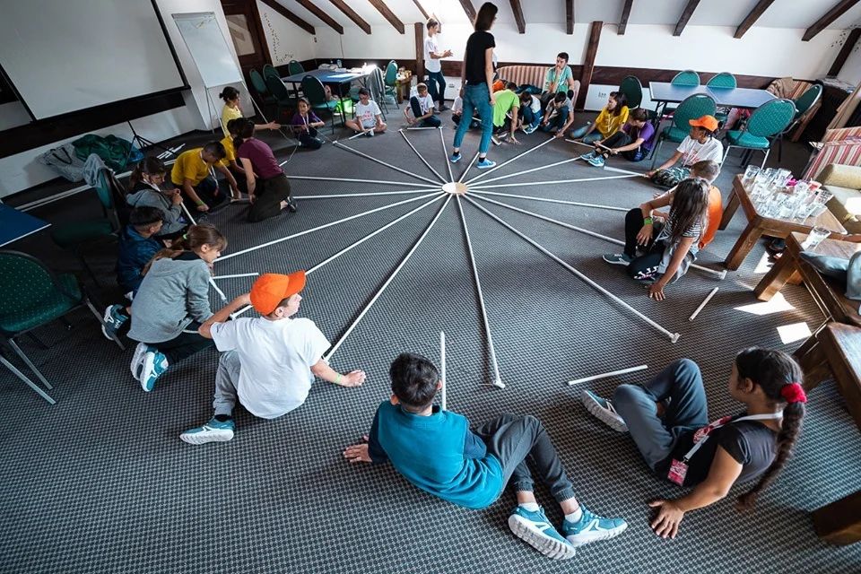Participants raising the umbrella dome structure
